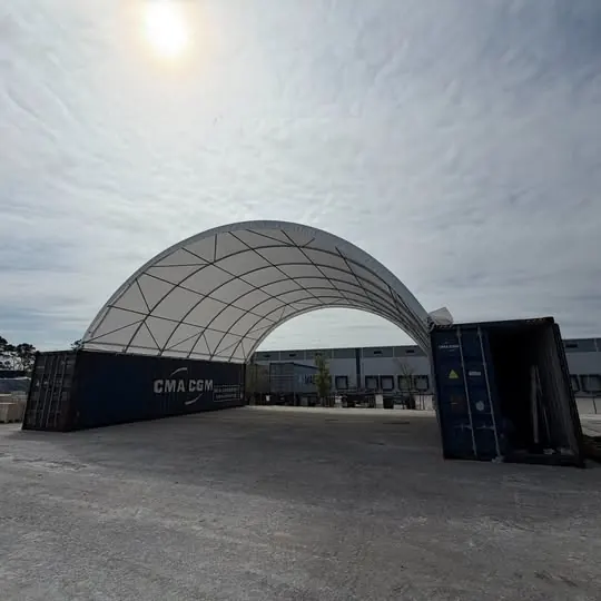 Arched shipping container canopy installed between two containers