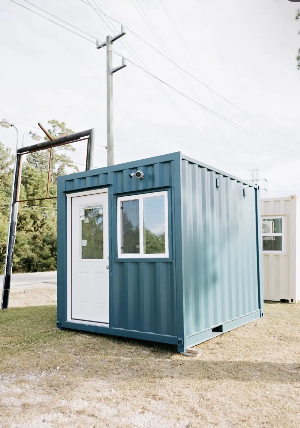 Teal container guard shack with visibility windows
