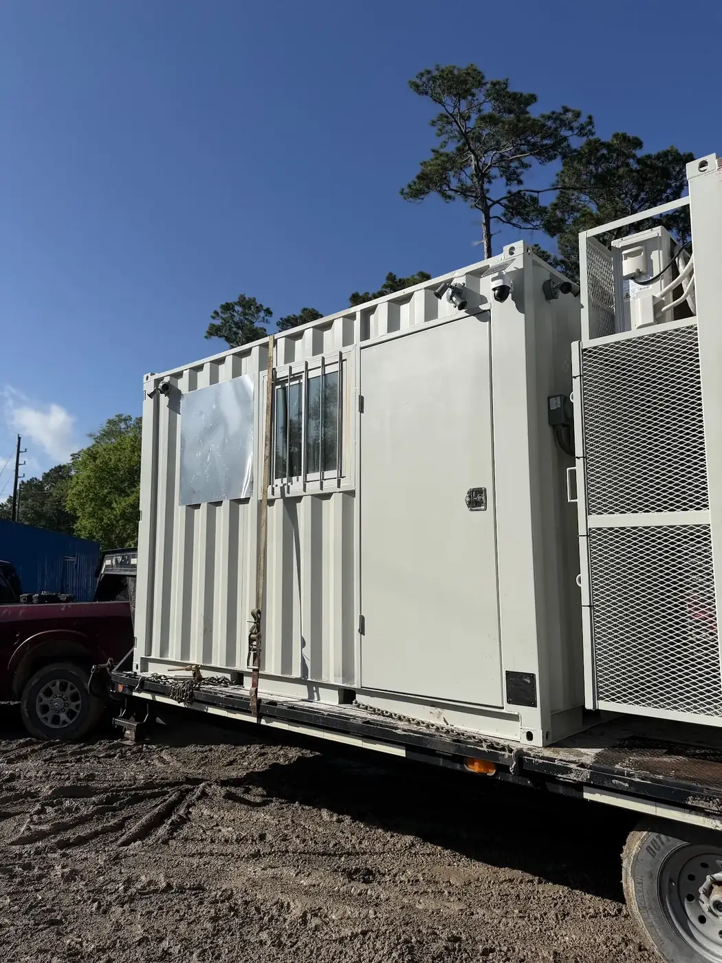 Container generator enclosure with caged equipment on trailer